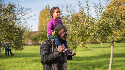 Visitors in the Orchard on Apple Day at Barrington Court, Somerset